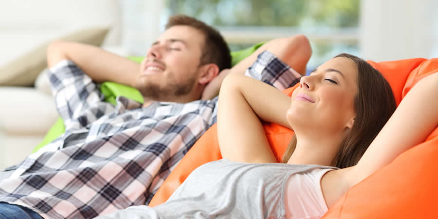Healthy Couple Relaxing On Their Sofa