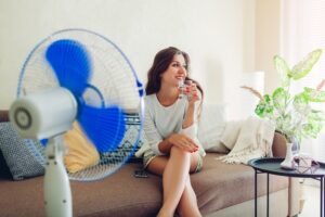 Woman Enjoying Cooling From Fan