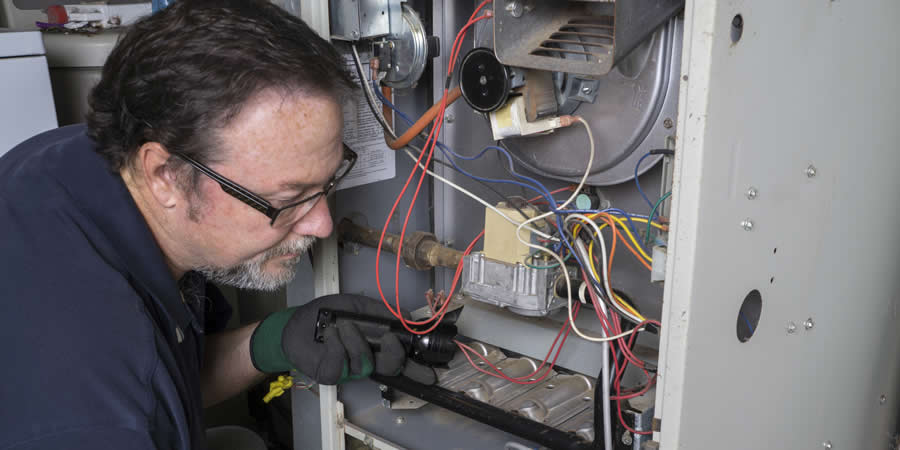 hvac-tech-repairing-furnace