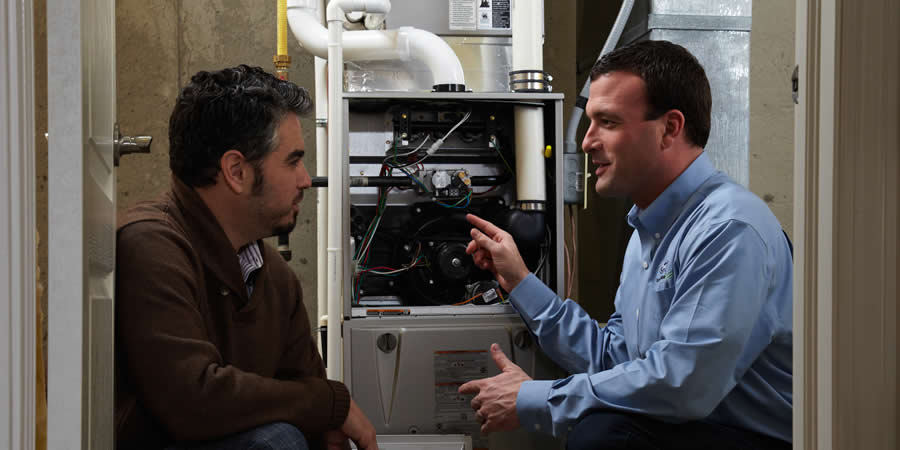 hvac-tech-talking-to-homeowner-about-furnace