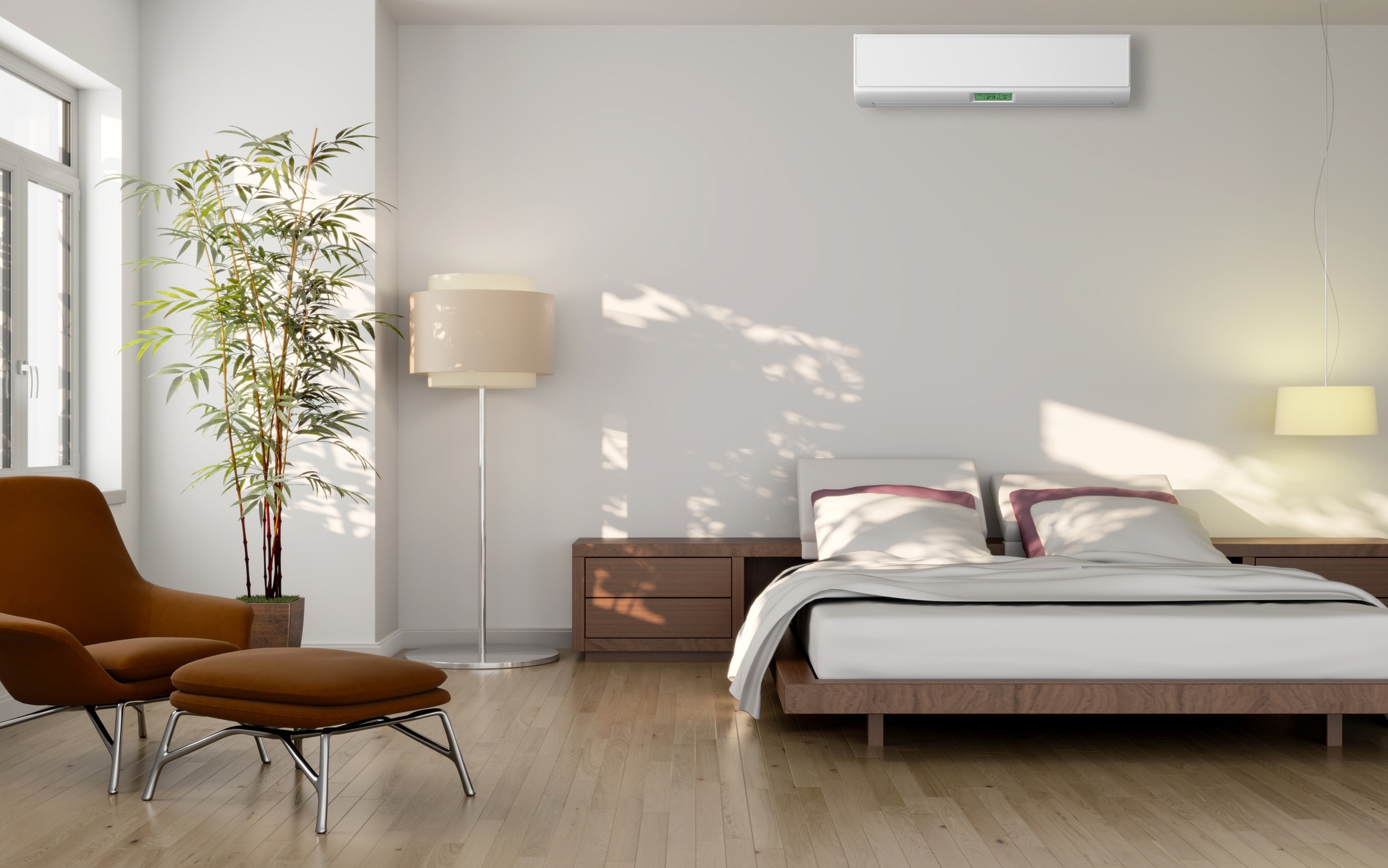 modern bedroom with ductless ac unit on wall over bed